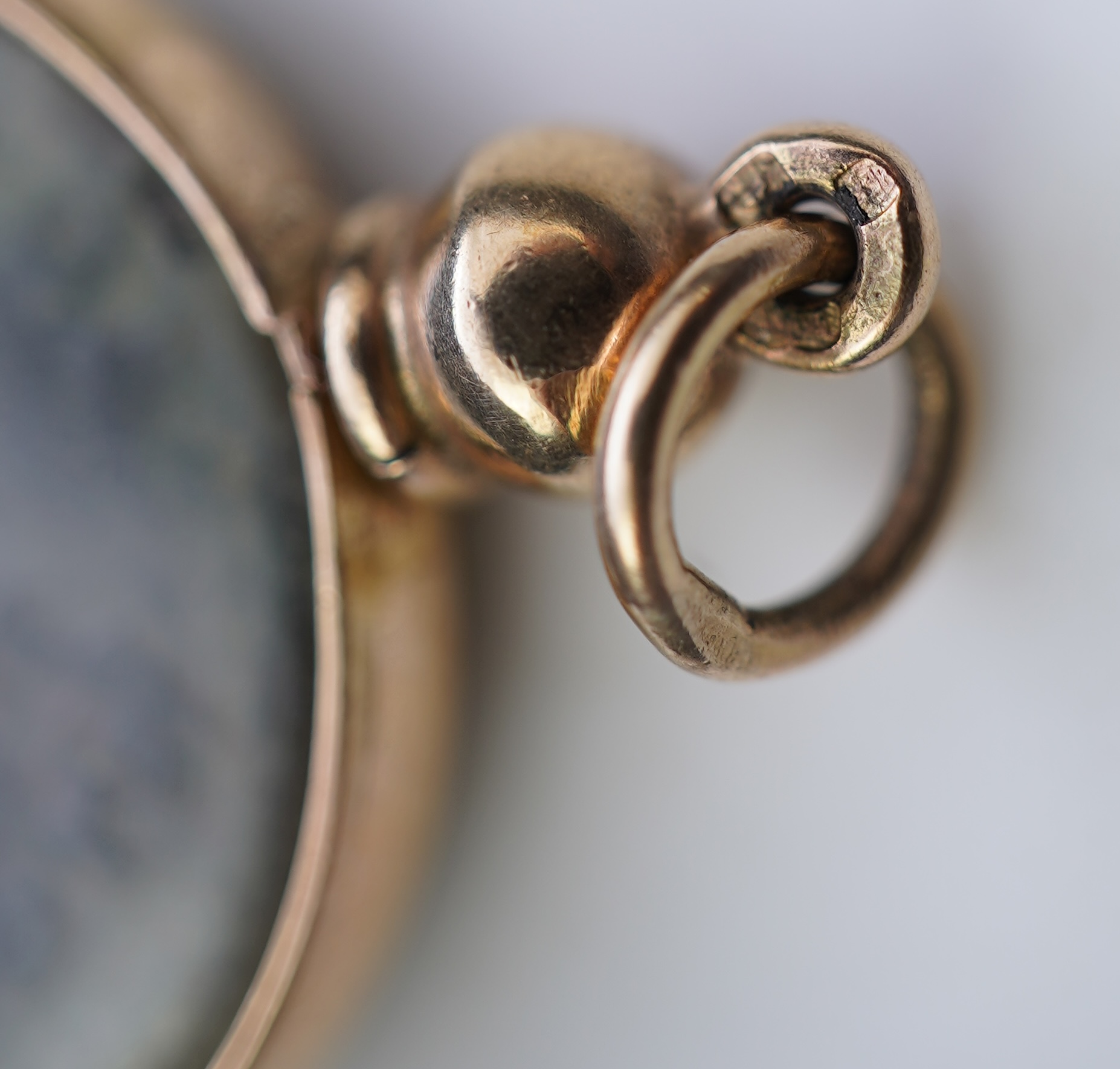 A gold and Roman bronze coin pendant